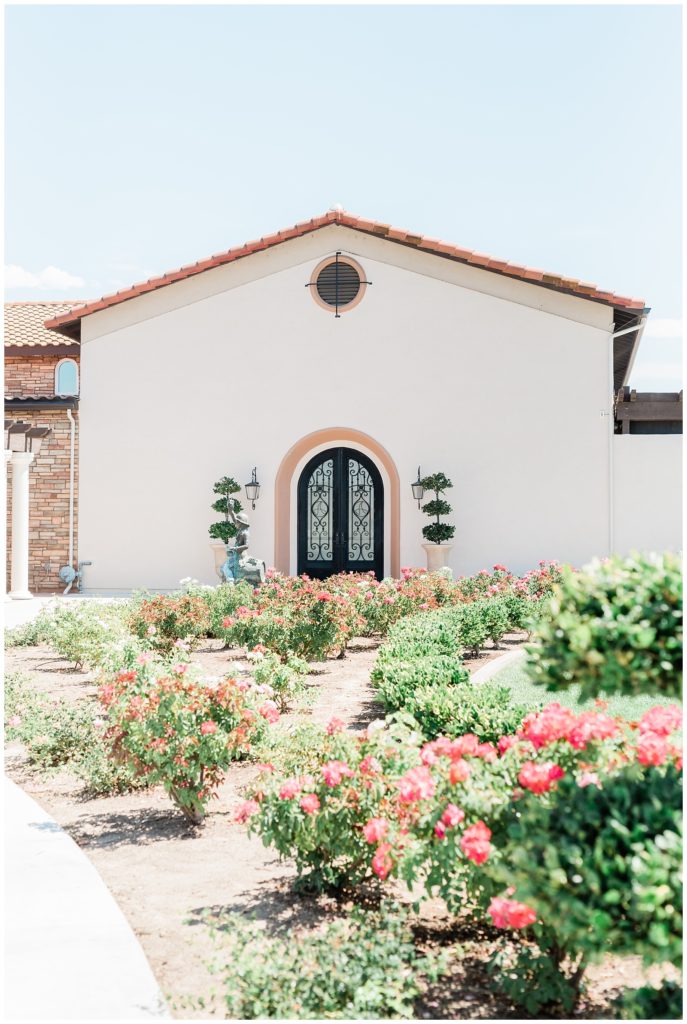 Lush gardens leading up to the signature front doors in Spanish-style architecture at Avensole Winery in Temecula, California.