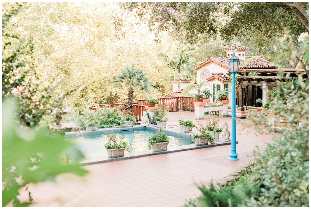 Open-air wedding venue featuring a fountain and antique blue streetlights in Southern California, by Orange County wedding photographer.