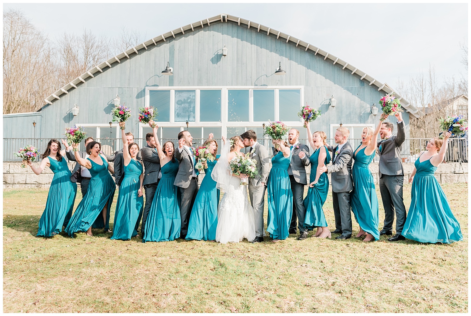 Bride and groom kissing and bridal party cheering in bright colors at the Lake House Inn.