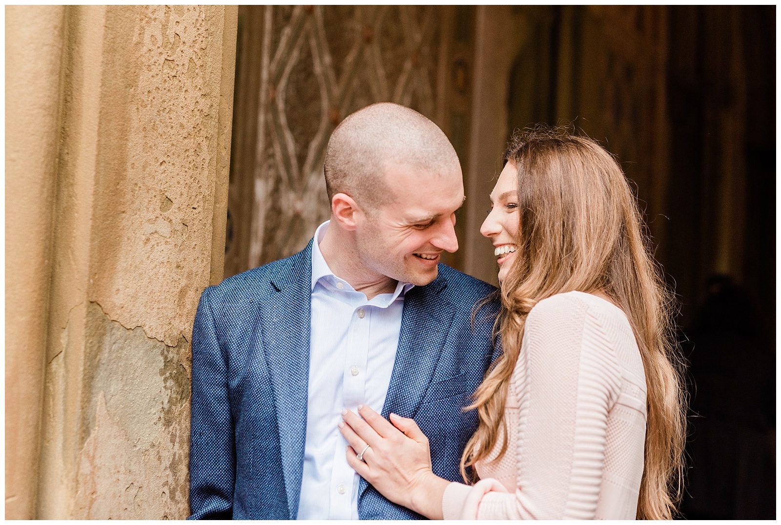 A couple laughs together in the entryway of Bethesda Terrace.