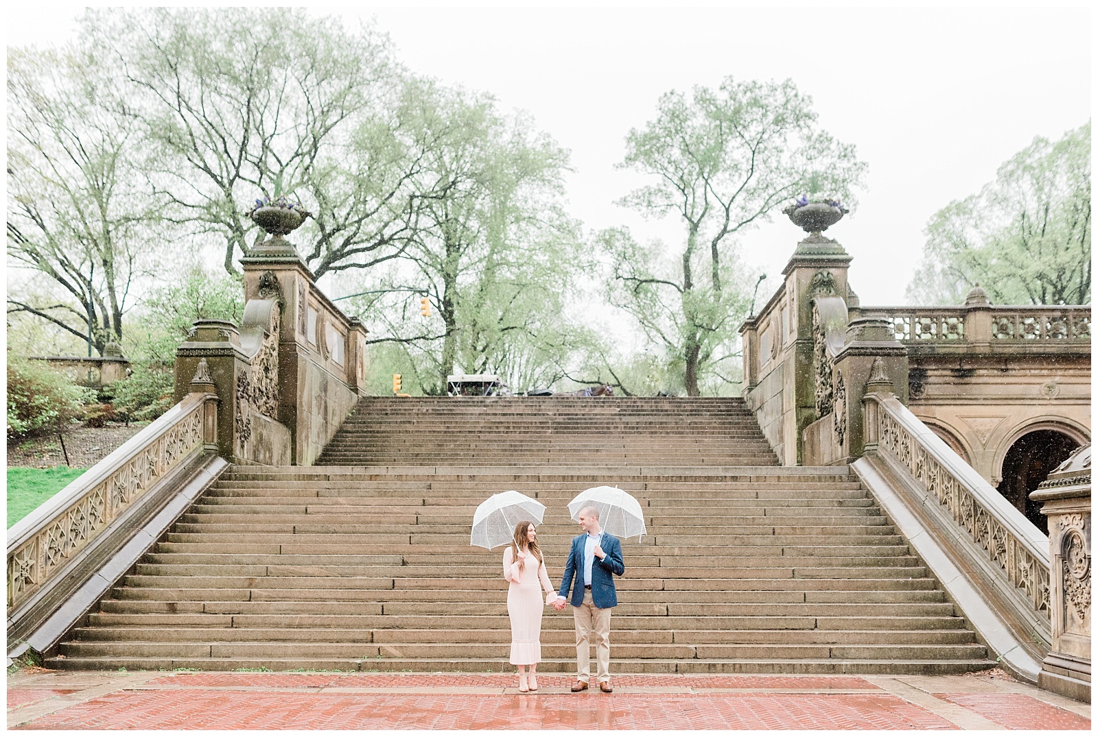 A couple holds hands in front of a large staircase in Central Park NYC.