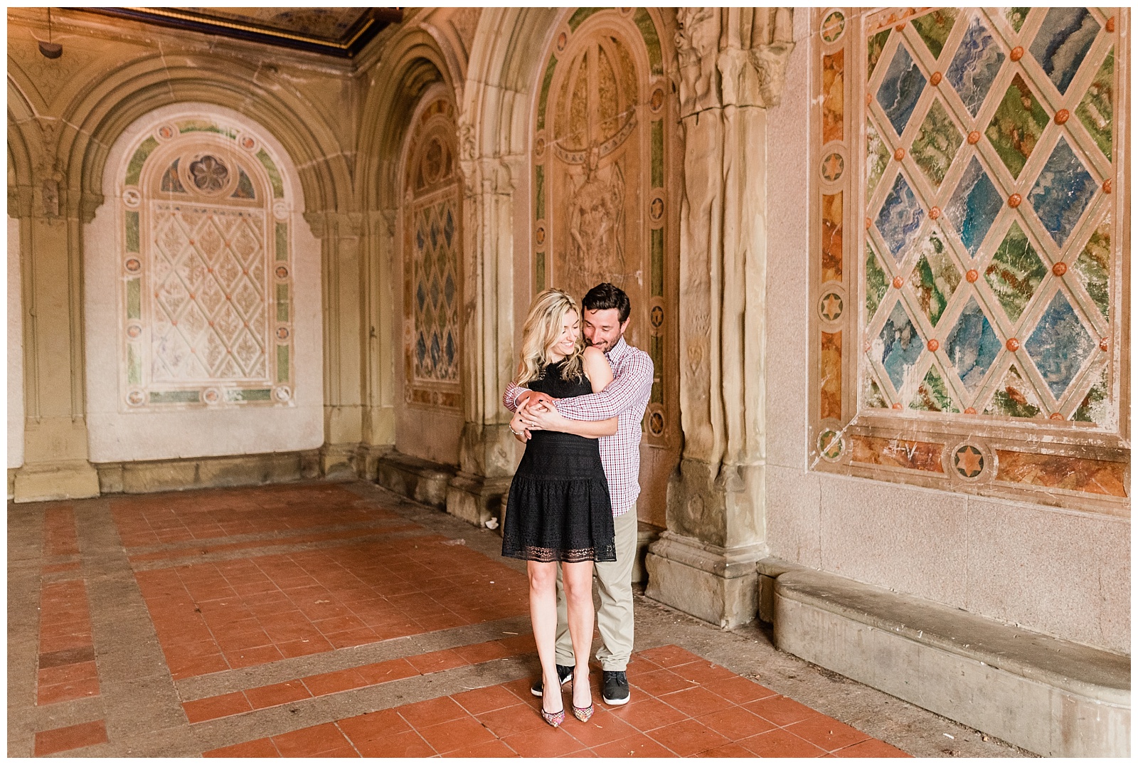A man holds his fiance from behind in Bethesda Terrace at Central Park, New York.
