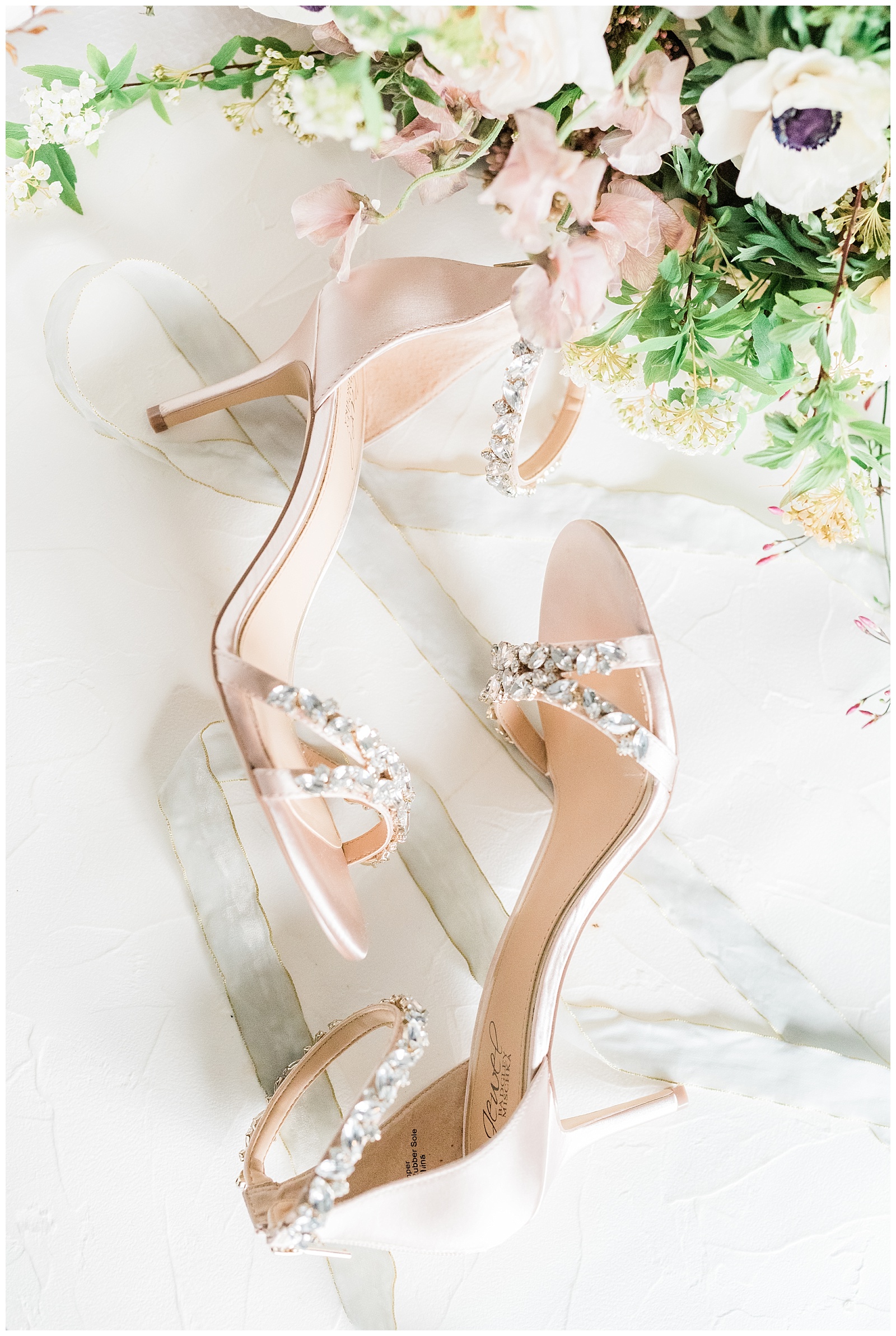 Blush Badgley Mischka high heels styled with a ribbon and bouquet.