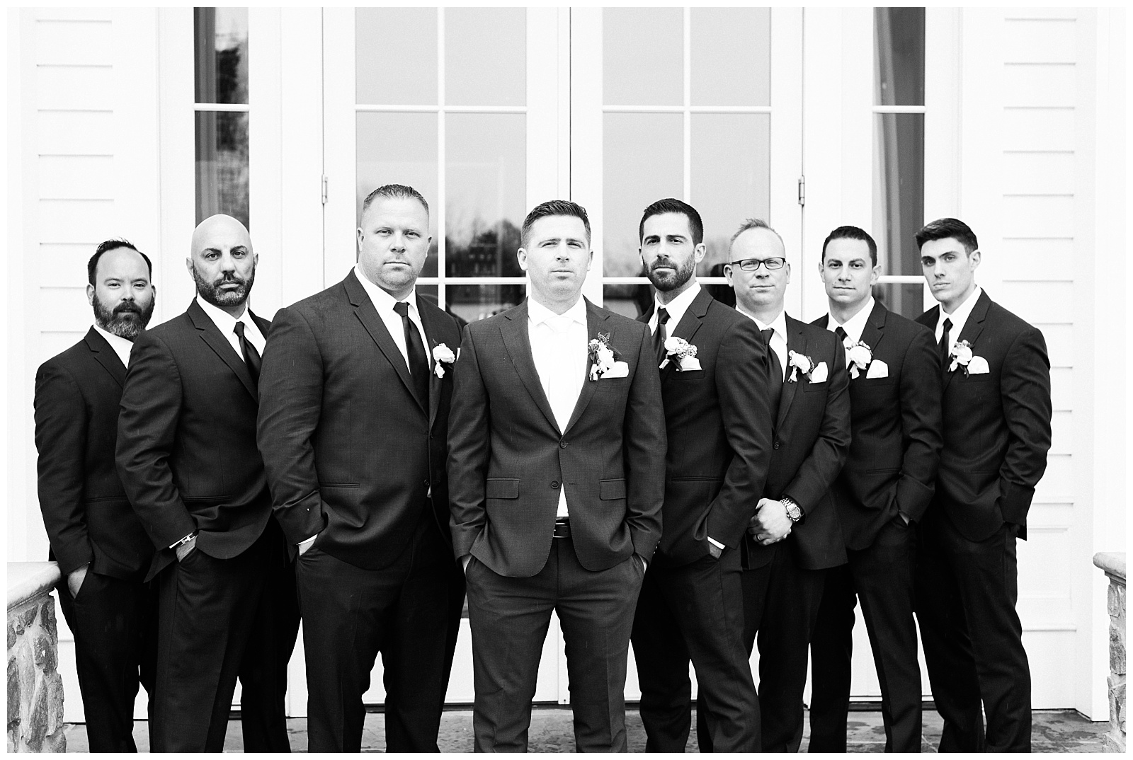 Black and white photo of groomsmen standing together.