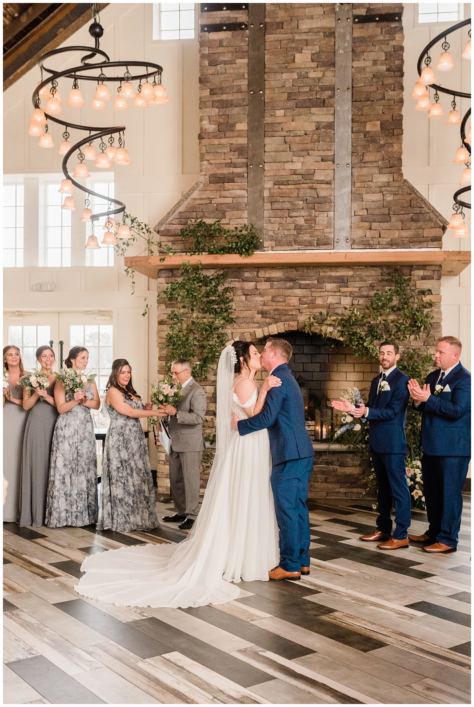 Bride and groom share their first kiss after their wedding ceremony in the Coach House at the Ryland Inn.