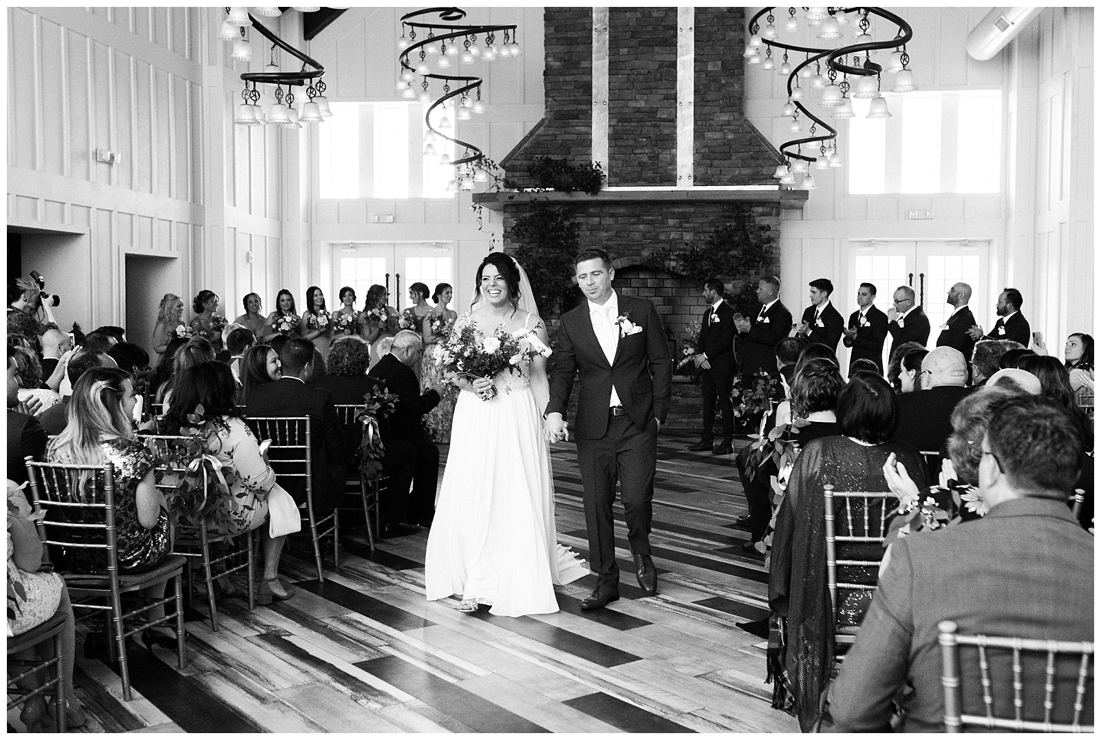 Bride and groom exit the ceremony after exchanging vows inside the Coach House at Ryland Inn.