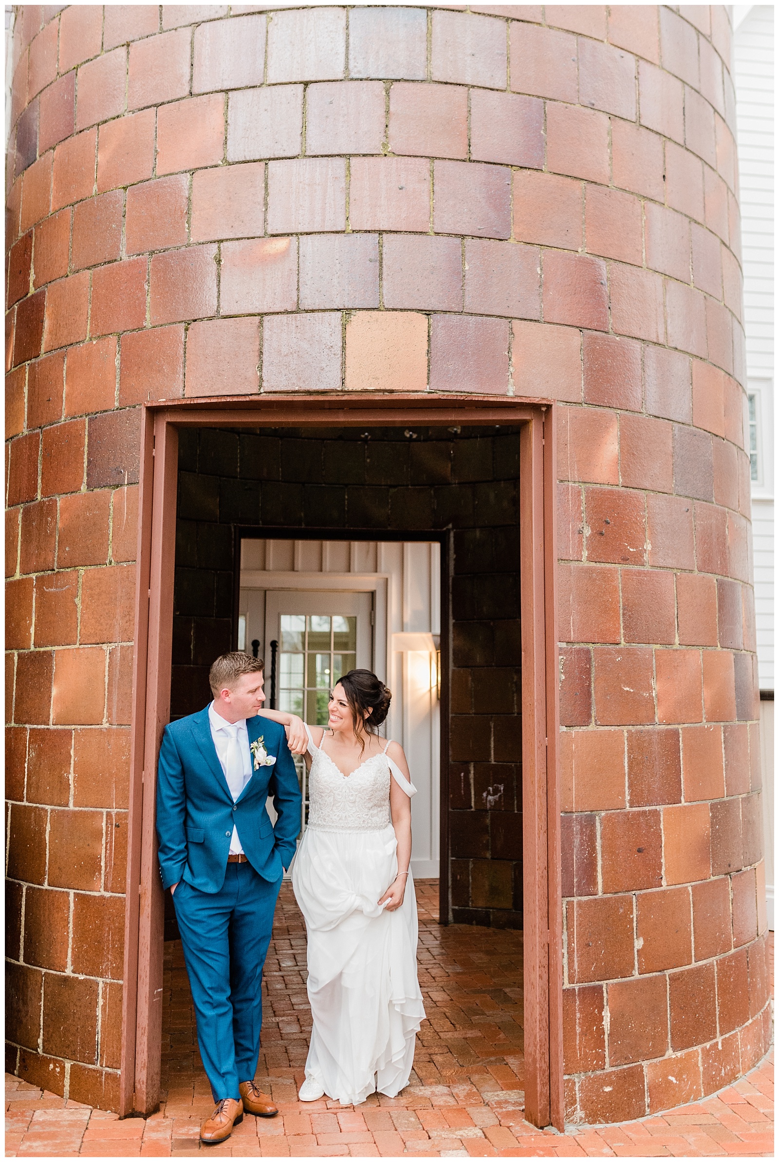 Bride leans on the groom's shoulder in the doorway of a silo at the Coach House at Ryland Inn.