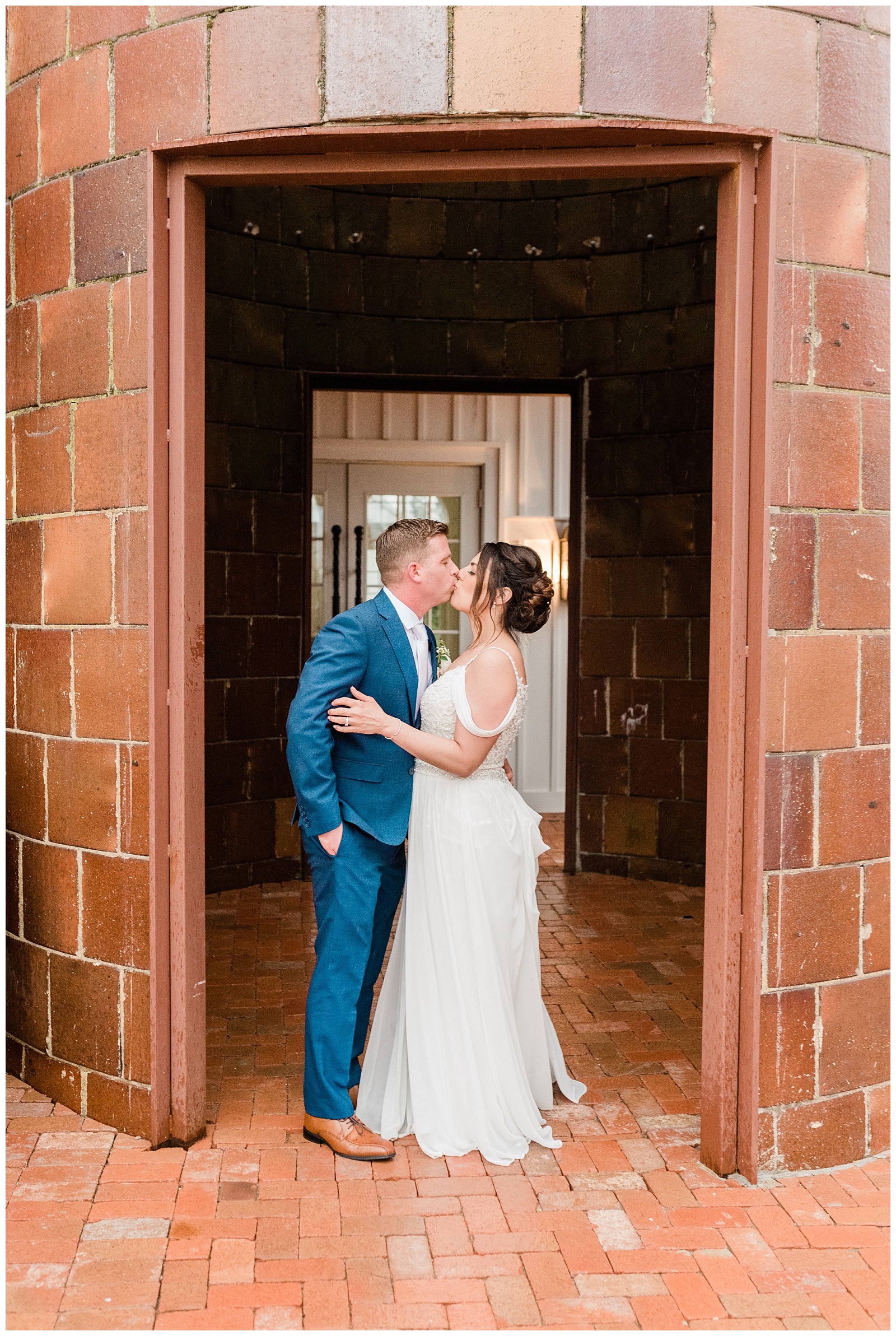 Bride and groom kiss in the doorway of a silo at the Coach House at Ryland Inn.
