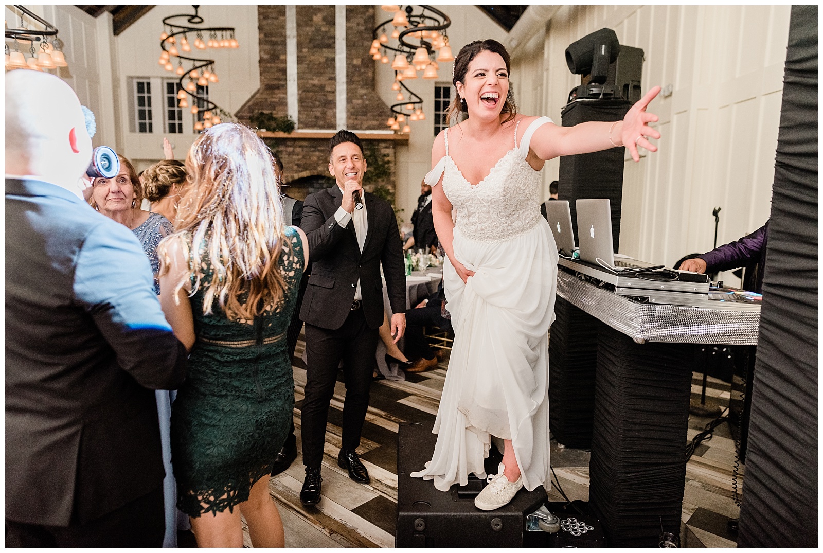 Bride dances during the reception and stands on a speaker.