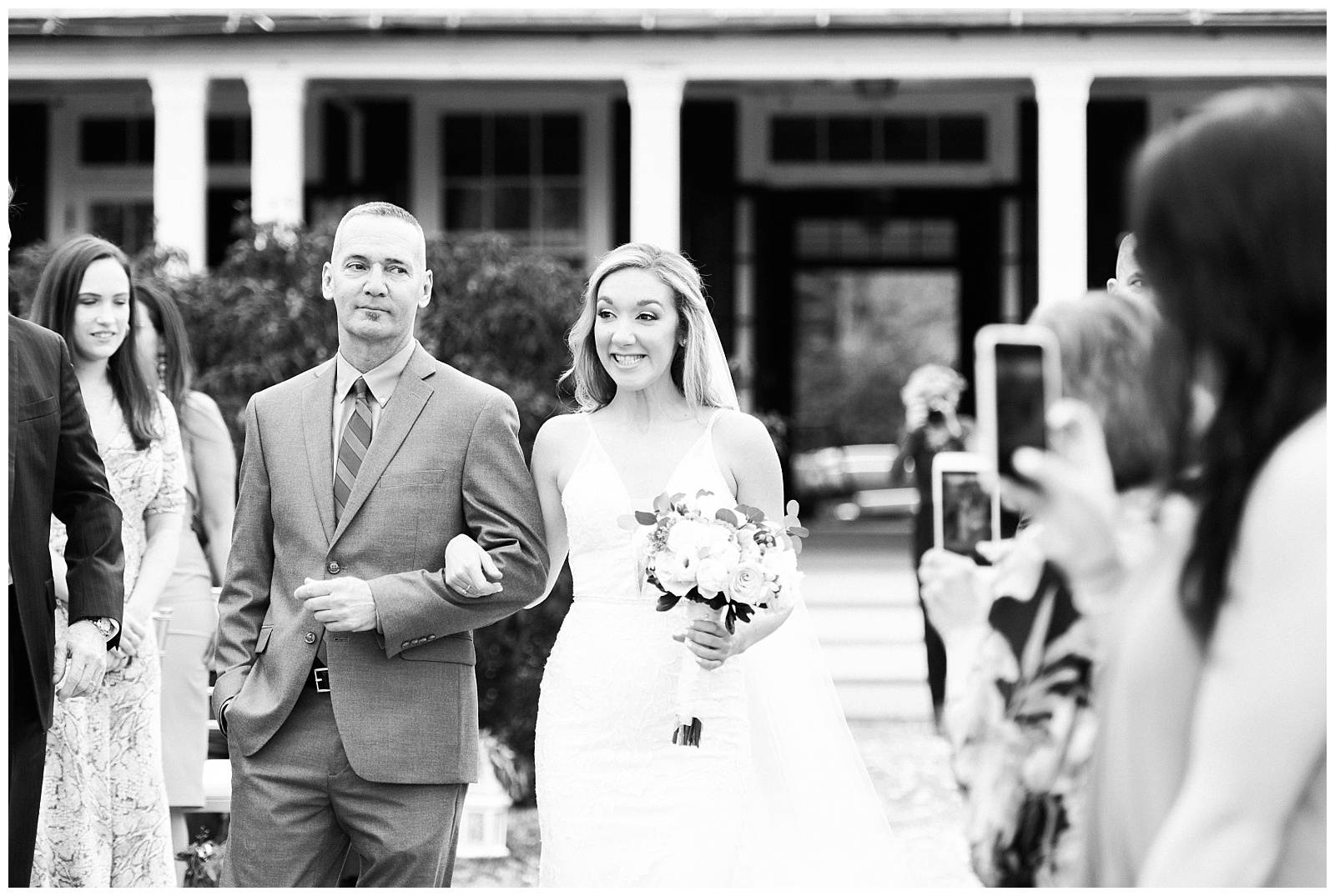 The bride and her dad walk together down the aisle during the ceremony.