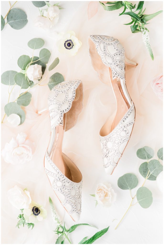 Badgley Mischka wedding shoes are styled with loose floral pieces.