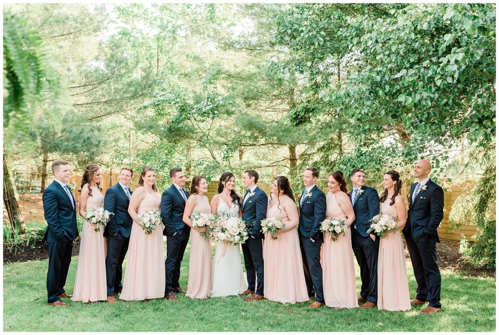 A bridal party looks at one another.