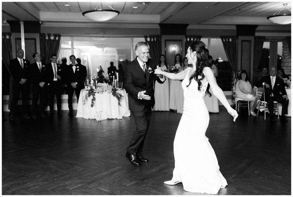 A bride dances with her dad during the wedding reception.