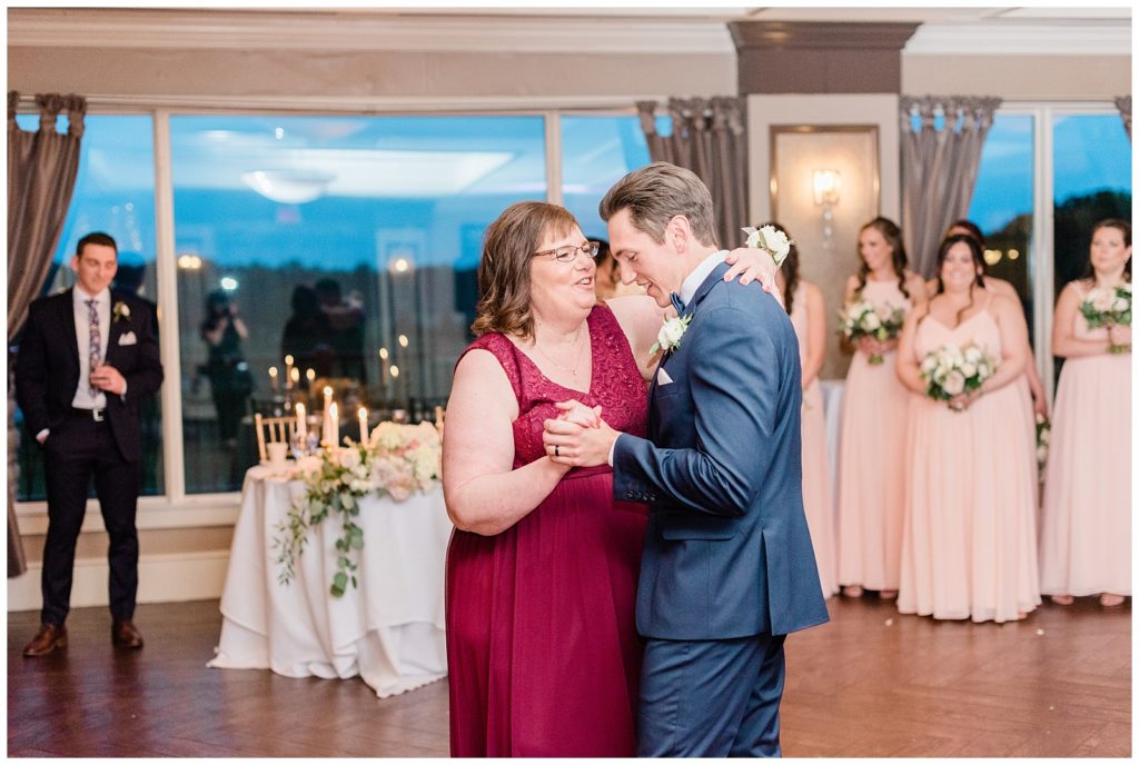 The groom dances with his mom at the reception.