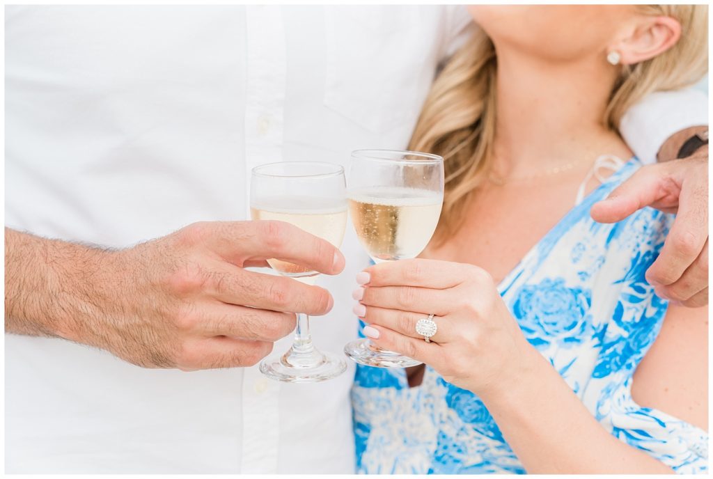 A couple toasts champagne glasses together.
