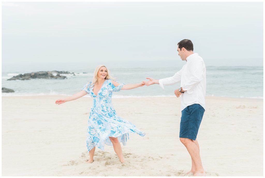A couple dances together on the beach.