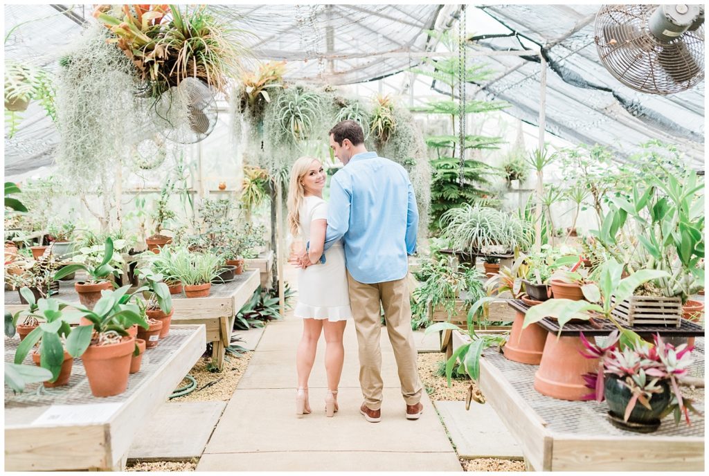 A couple hugs inside a greenhouse in New Jersey.
