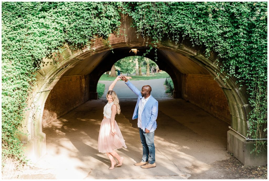 A couple slow dances in front of the trefoils arch in Central Park.