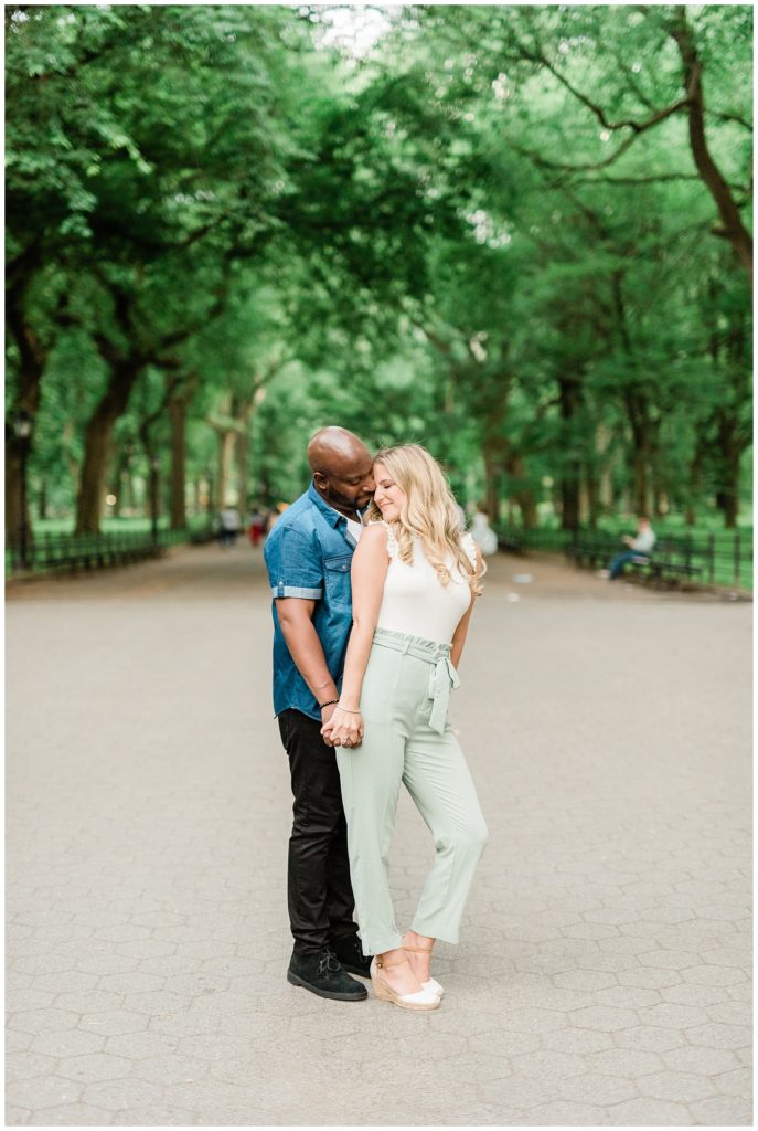 A couple enjoys a quiet moment in the tree lined path of the mall at Central Park.