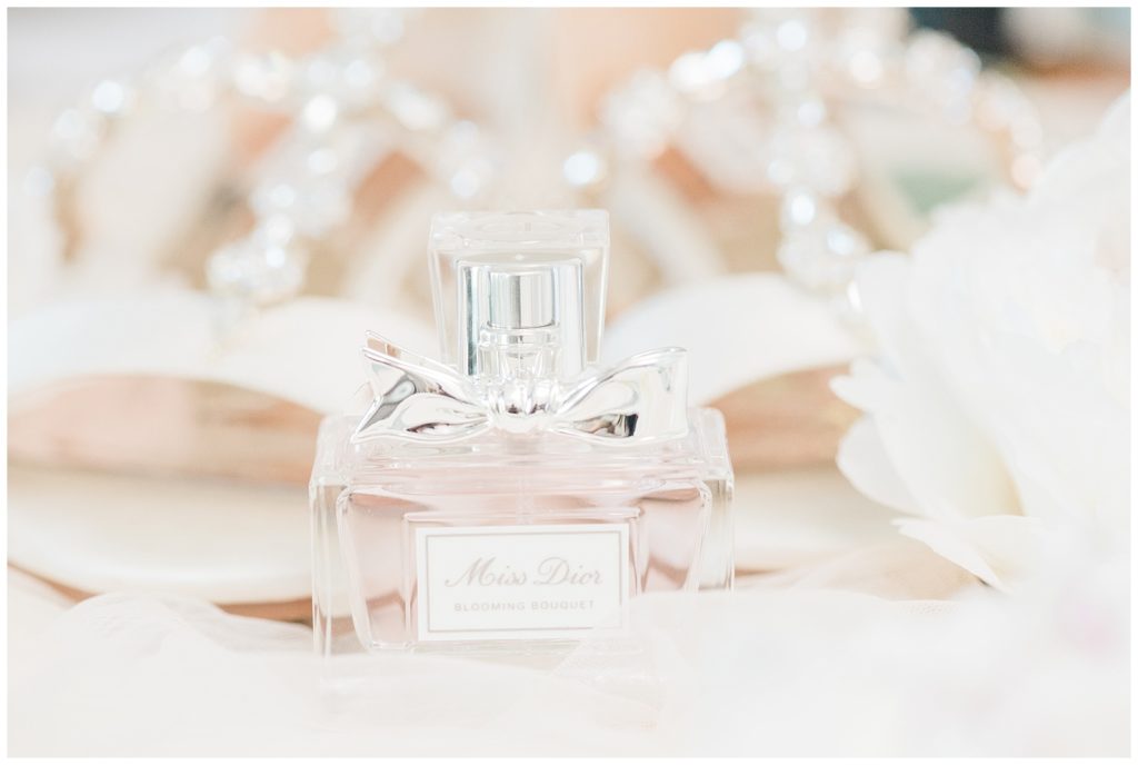 Blooming bouquet perfume bottle styled with bridal shoes.