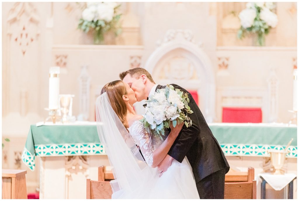 Bride and groom share their first kiss as husband and wife in the church.