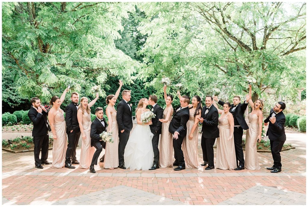 Bridal party cheers in the courtyard at the Estate at Florentine Gardens.