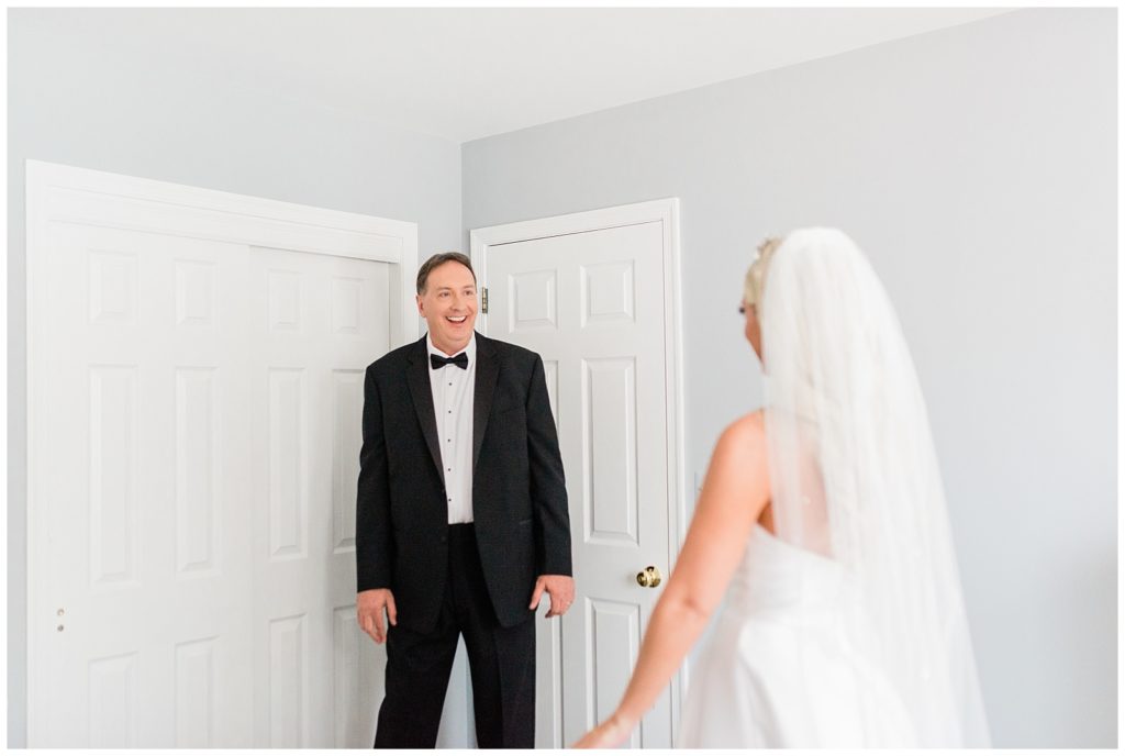 The bride shares a first look with her dad, as he sees her for the first time in her wedding dress.