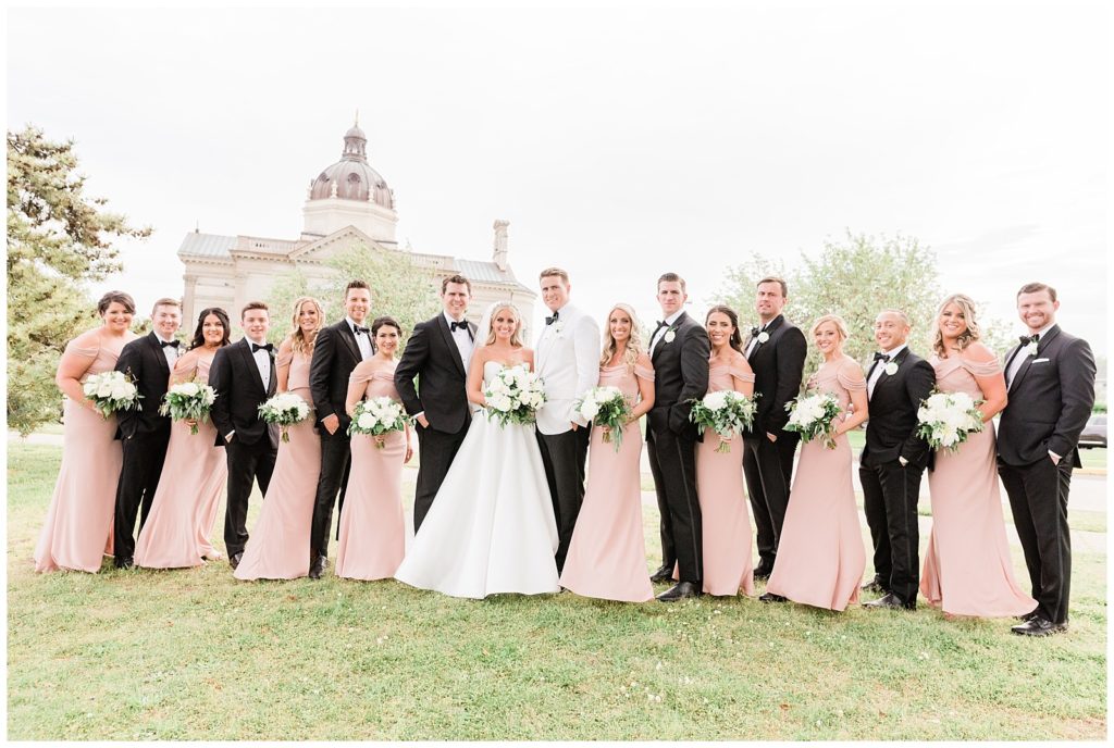 The bridesmaids and groomsmen pose for a photo outside St. Catharine's Church in Spring Lake.