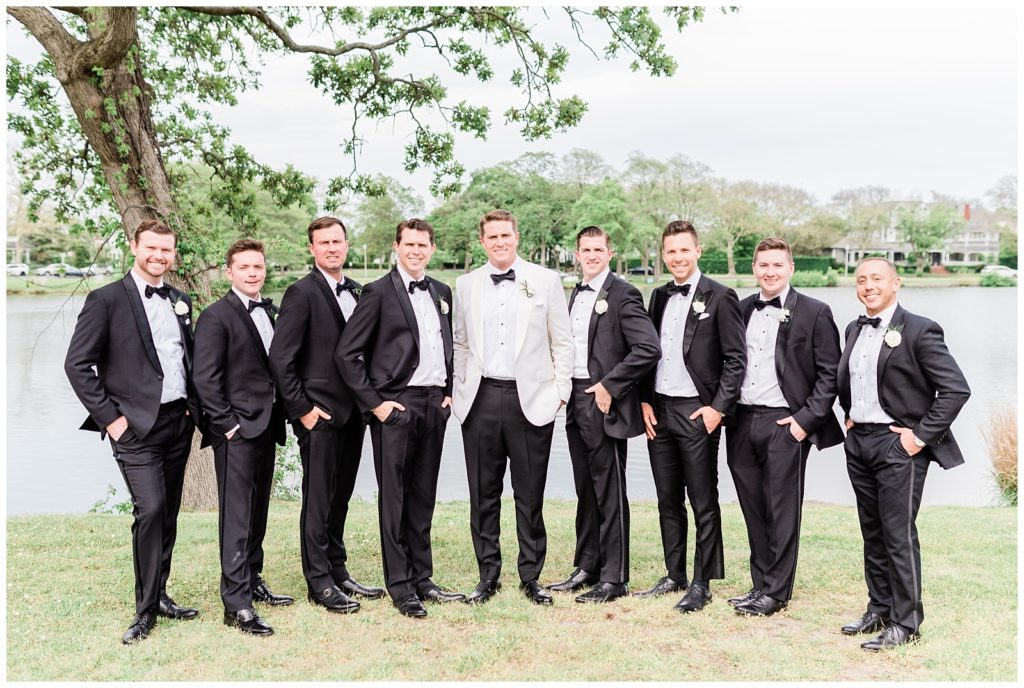 The groom and his groomsmen are photographed in Divine Park.