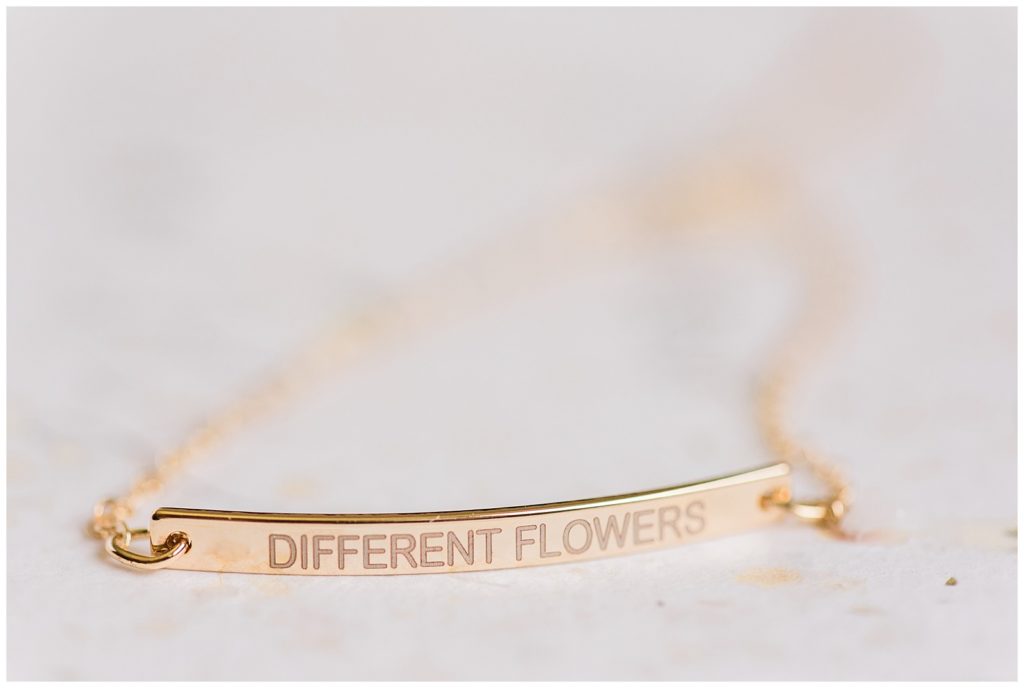 Gold bar bracelet reading "different flowers" for a house party sister gift.