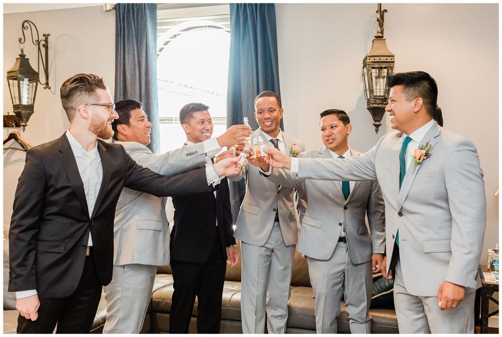 Groom on his wedding day toasts with his groomsmen in the groom suite at Avensole Winery in Temecula, California.