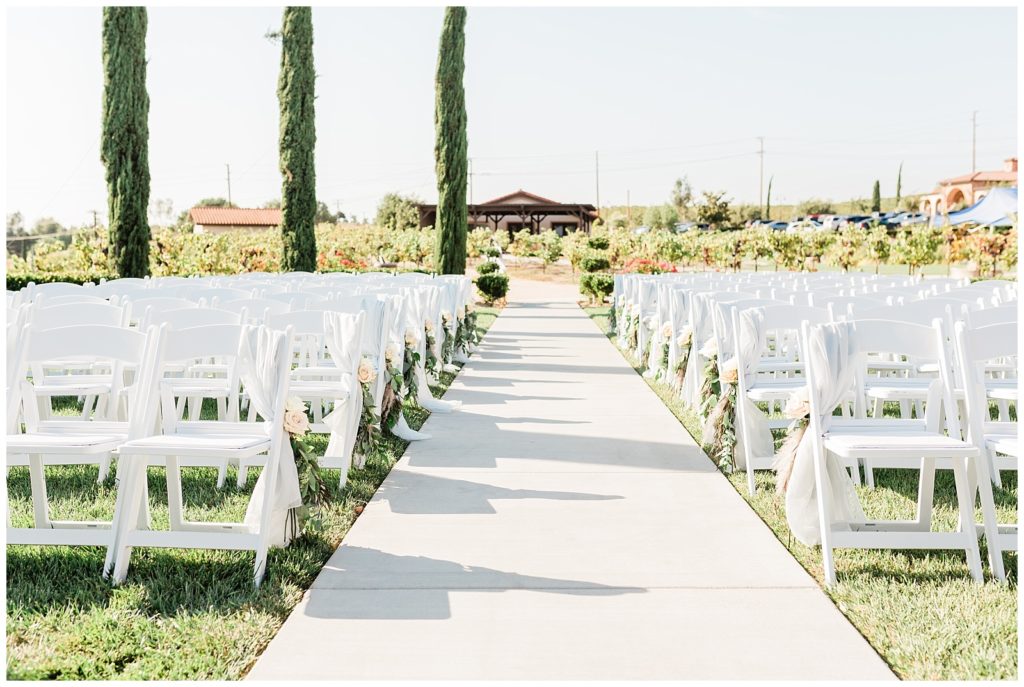 View from the front of the ceremony looking back down the aisle at Avensole Winery wedding venue in Temecula, California.
