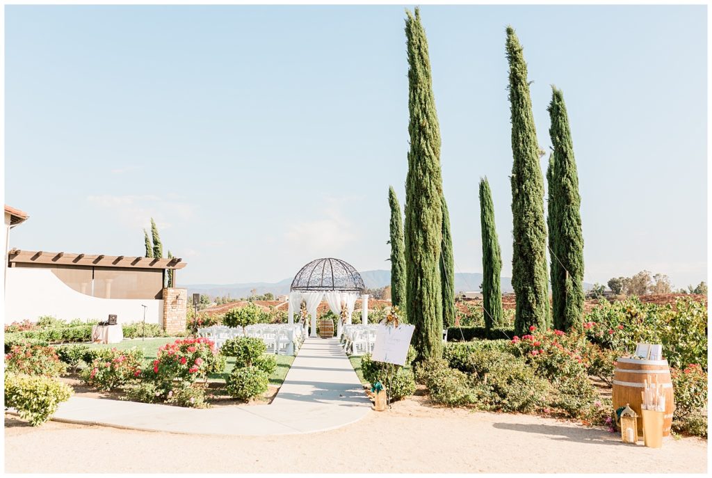 Wide view of the ceremony space at Avensole Winery wedding venue overlooking the vineyards of Temecula, California.