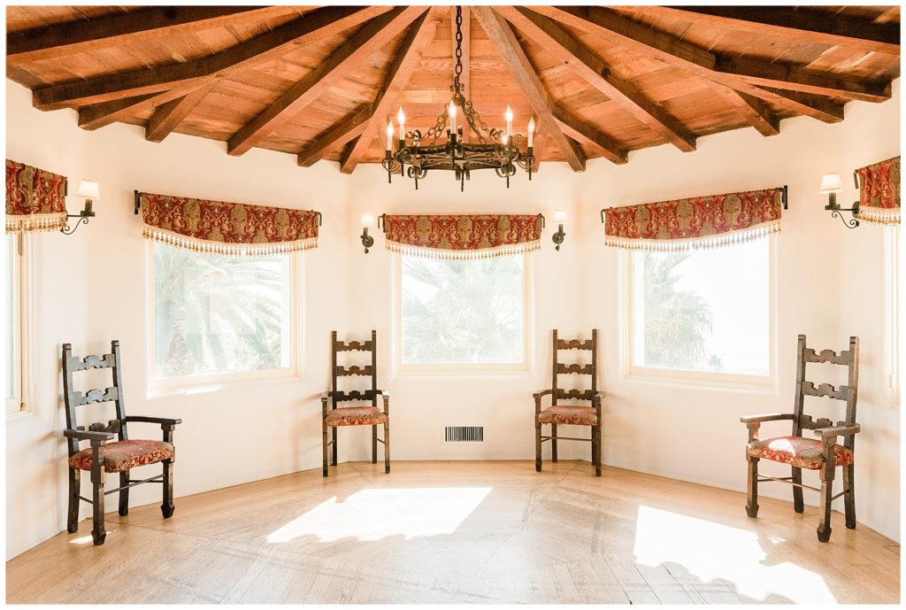 A round room with a wooden ceiling, and several windows where groom's can get ready for their wedding day at Casa Romantica in Orange County, CA.