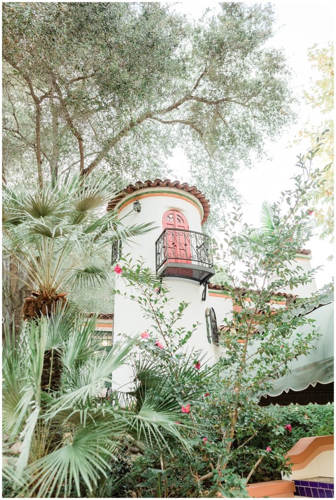 View of the tower of Rick's cafe with a red door and balcony at Rancho Las Lomas in Orange County, California.