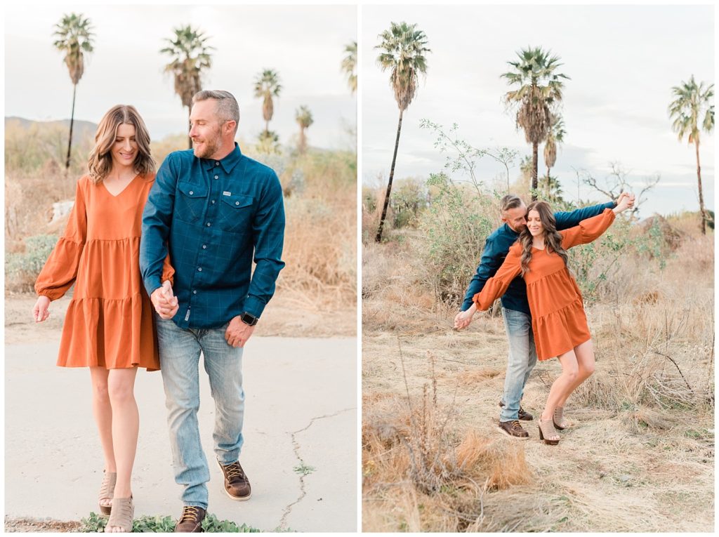 Engagement photos of a couple laughing together and walking down a path at Fairmount Park in Riverside, California.